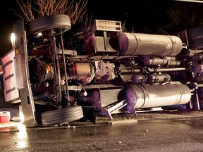 Lakeshore firefighters, Essex-Windsor EMS paramedics and OPP rescue the driver of an overturned Freightliner tractor trailer carrying auto parts destined for Honda Plant in Alliston, Ont. March 3, 2015.  The injured driver was transported to hospital with minor injuries. (NICK BRANCACCIO/The Windsor Star)