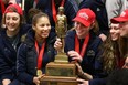 Tessa Kreiger, from left, Korissa Williams, Courtney VandeBovenkamp, Kristine Lalonde and Carly Steer pose with the Bronze Baby Trophy after the CIS champion Windsor Lancers arrived at the Windsor International Airport Monday night. (DAX MELMER/The Windsor Star)
