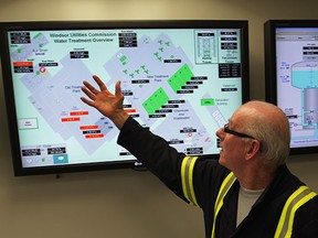Mick McIntyre scans water treatment overview display screens in the control room at A.H. Weeks Water Treatment Plant on Wyandotte Street East, March 5, 2015.  (NICK BRANCACCIO/The Windsor Star)