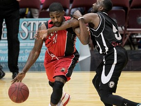 Windsor Express guard Tony Bennett locks the arm of Mississauga's Omar Strong during NBL of Canada playoff action at WFCU Centre, Tuesday March 10, 2015. Bennett broke free and scored an uncontested layup. (NICK BRANCACCIO/The Windsor Star)