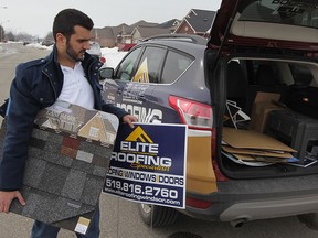 David Melo, a project manager from Elite Roofing signed up another customer for a new roof in Lakeshore, Tuesday March 10, 2015.  (NICK BRANCACCIO/The Windsor Star)