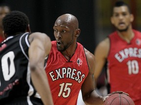 Windsor Express Quinnel Brown leads the play against MIS Power Marcus Capers, left, in NBL Canada playoff action at WFCU Centre, Tuesday March 10, 2015. (NICK BRANCACCIO/The Windsor Star)