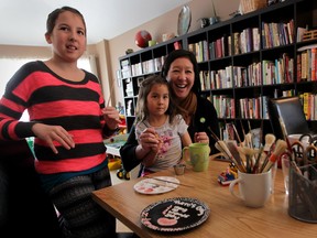 Windsor, ON. March 10, 2015 --  Rachelle Hartigan and children Layla, 10, left, and Maggie, 6, have a laugh while painting coffee mugs and saucers, Tuesday March 10, 2015.  (NICK BRANCACCIO/The Windsor Star)
