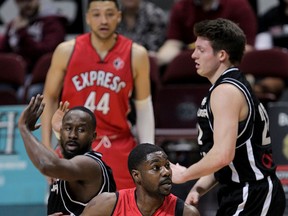 Windsor Express Tony Bennett breaks away from Mississaugae Power Omar Strong, left, and Jordan Weidner in NBL Canada playoff action at the WFCU Centre.