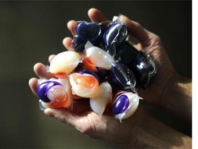 In this photo taken Friday, Nov. 7, 2014, laundry detergent packets are held for a photo, in Chicago. Accidental poisonings from squishy laundry detergent packets sometimes mistaken for toys or candy landed more than 700 U.S. children in the hospital in just two years, researchers report. Coma and seizures were among the most serious complications. (AP Photo/Charles Rex Arbogast)