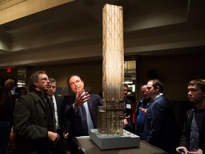 Sam Mizrahi, centre, speaks during a community meeting Wednesday about his proposal to build an 80-storey mixed-use building at the southwest corner of Yonge and Bloor streets in Toronto. It would be the tallest building in Canada.