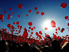 A picture taken on March 15, 2015 shows people releasing red balloons during a flashmob at St. Petersburg's Palace square.