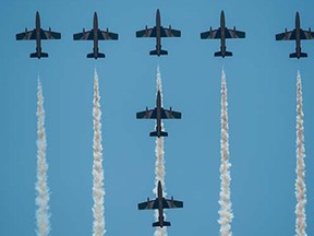 United Arab Emirates (UAE) Air Force aerobatic team Fursan planes perform during the Langkawi International Maritime and Aerospace Exhibition 2015 (LIMA15) in Malaysia's resort island of Langkawi on March 18, 2015. Lima'15 is the premier destination for aerospace and maritime manufacturers targeting the Asia Pacific growth markets from the defence, enforcement, civil and commercial sectors.