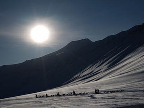 TOPSHOTS Eclipse watching tourists ride dog sleds outside of Longyearbyen, Svalbard, an archipeligo administered by Norway on March 19, 2015 ahead of the March 20 total solar eclipse in Longyearbyen, Svalbard, an archipeligo administered by Norway. Thousands are gathering here as the only land the total eclipse will be seen from is on Svalbard and the Faoroe Islands off Iceland. AFP PHOTO / STAN HONDASTAN HONDA/AFP/Getty Images