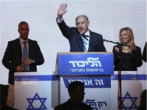 Israeli Prime Minister Benjamin Netanyahu greets supporters at the party's election headquarters in Tel Aviv. After a strong performance in last week's parliamentary election, Netanyahu seems to be cruising toward forming a new government of hardline and religious parties. But in the smoke-and-mirrors world of Israeli politics, a centrist government more amenable to peace negotiations could easily emerge at the last minute instead.
(Postmedia News Files)