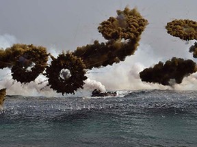 South Korean Marine amphibious assault vehicles fire smoke shells to land on the seashore during a joint landing operation by US and South Korean Marines in the southeastern port of Pohang on March 30, 2015. The drill is part of the annual joint exercise Foal Eagle to enhance the combat readiness of the US and South Korea supporting forces in defense of the Korean Peninsula.