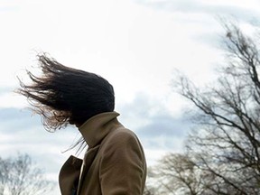 A woman has her hair fluttering in the wind during stormy weather near the lake Ammersee in the small Bavarian village of Herrsching, southern Germany, on March 31, 2015. Storm front "Niklas" sweeping over the whole country reaches a speed of 140 km/h, according to meteorologists.