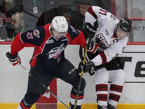 Spits Hayden McCool battles Guelph Storm Jason Dickinson for puck in OHL action from WFCU Centre Thursday March 12, 2015.  (NICK BRANCACCIO/The Windsor Star)