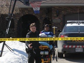 Essex-Windsor EMS paramedics leave with their equipment as  OPP officers remained at the scene at 307 Centennial Dr. in Tecumseh where the body of a deceased man was found Thursday March 12, 2015.  (NICK BRANCACCIO/The Windsor Star)