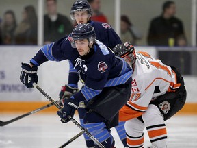 Amherstburg Admirals Luke Gangnon, left, is hounded by Essex 73's Matthew Hebert in Game 6 of Junior C Finals playoff game at Libro Centre Friday March 13, 2015. (NICK BRANCACCIO/The Windsor Star)