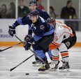 Amherstburg Admirals Luke Gangnon, left, is hounded by Essex 73's Matthew Hebert in Game 6 of Junior C Finals playoff game at Libro Centre Friday March 13, 2015. (NICK BRANCACCIO/The Windsor Star)