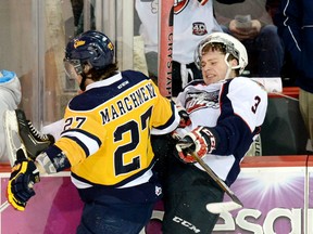 Windsor's Liam Murray is checked by Erie's Jake Marchment during Saturday's 4-1 loss to the Otters in Erie. (Jack Hanrahan/Erie Times News)