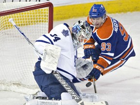 Toronto goalie James Reimer, left, makes a save on Edmonton's Ryan Nugent-Hopkins (93) Monday in Edmonton. (THE CANADIAN PRESS/Jason Franson)