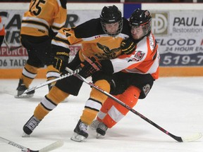 Exeter's Dylan Wilson-Foote, left, collides with Essex's Daniel McIntyre in the first period in the opening game of the Schmalz Cup quarter final series between the Essex 73's and the visiting Exeter Hawks at Essex Arena Tuesday. (DAX MELMER/The Windsor Star)