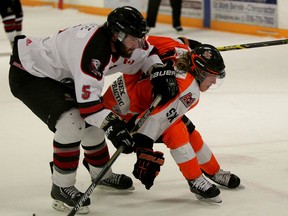 Essex's Tyler Scott, right, is checked by  Coleton Madge of the Ayr Centennials in the first period of the Schmalz Cup semifinal Tuesday in Essex. (NICK BRANCACCIO/The Windsor Star)