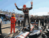 Will Power stands on his car after winning the first race of the IndyCar Detroit Grand Prix doubleheader in Detroit Saturday. (AP Photo/The Detroit News, Steve Perez)