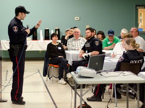 Windsor police senior constable Shane Renaud gives a safety presentation to over 70 west end community members at the Life After Fifty senior citizen centre Tuesday March 31, 2015. The crime prevention forum was a community initiative designed to help residents of west Windsor keep their homes and neighbourhoods safe. GABRIELLE SMITH/Special to the Windsor Star