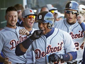 Detroit teammates laugh as Yoenis Cespedes, centre, bites his glove after hitting a  two-run homer against the Philadelphia Phillies Sunday in Clearwater, Fla. (AP Photo/Kathy Willens)
