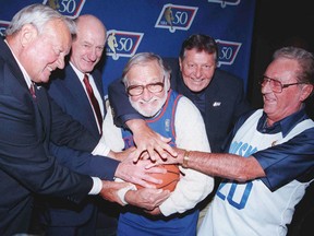 Windsor's Gino Sovran, second from left, was among former players who played with the  Toronto Huskies in the first NBA game in 1946. The others are, from left, Dick Schulz, Harry Miller and Ray Wertis. The are trying to steal the ball from former New York Knick Ossie Schectman, the first person to ever score a basket in the NBA. (AP Photo/The Canadian Press, Jeff McIntosh, File)