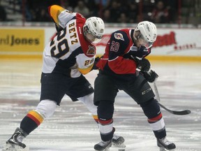 Windsor's Andrew Burns battles Erie's Nick Betz for the puck during OHL action between the Windsor Spitfires and the visiting Erie Otters at the WFCU Centre, Thursday,  March 19 2015.  (DAX MELMER/The Windsor Star)