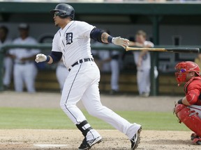 Detroit's Miguel Cabrera, left, singles to left field during the sixth inning of a spring training game against the Washington Nationals Sunday in Lakeland, Fla. (AP Photo/Carlos Osorio)