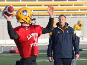 University of Windsor assistant coach Dan Lumley, right, watches quarterback Tommy Robertson during spring practice Tuesday. (JASON KRYK/The Windsor Star)
