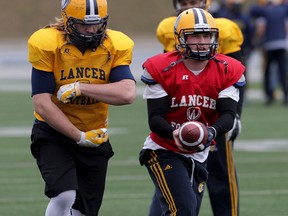 University of Windsor Lancers fullback Nate O'Halloran and quarterback Casey Wright during drills at Alumni Field March 26, 2015. (NICK BRANCACCIO/The Windsor Star)