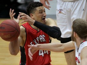 Windsor's Ryan Anderson, left, has the ball slapped away by Brampton's Zane Johnson in the first quarter Thursday at the WFCU Centre. (NICK BRANCACCIO/The Windsor Star)