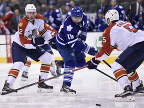 Belle River's Aaron Ekblad, right, and teammate Jimmy Hayes, left, check Toronto's Joffrey Lupul Thursday at the Air Canada Centre in Toronto. (THE CANADIAN PRESS/Frank Gunn)