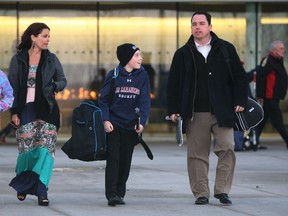Bill Bowler, right, and his wife Lindsay leave the Atlas Tube Centre with children Madelyn, left, and Ben. The Bowlers have another son, Jack. (NICK BRANCACCIO/The Windsor Star)