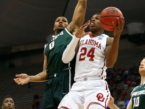 Oklahoma's Buddy Hield, right, takes a shot against Michigan State's Marvin Clark Jr. during the first half of the game at the East Regional Semifinal in Syracuse, N.Y. (Photo by Maddie Meyer/Getty Images)
