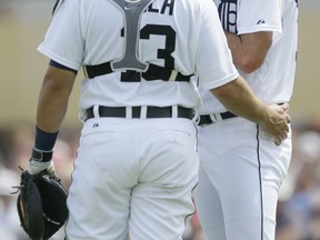 Detroit Tigers pitcher Justin Verlander, right, talks with catcher Alex Avila during the second inning of a spring training game against the Washington Nationals Sunday in Lakeland, Fla. (AP Photo/Carlos Osorio)