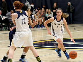 Windsor's Kristine Lalonde, right, dribbles the ball against the Toronto Varsity Blues Saturday at the St. Denis Centre. (RICK DAWES/The Windsor Star)