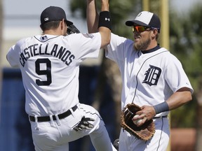 Detroit third baseman Nick Castellanos, left, and first baseman Jordan Lennerton celebrate their 4-3 win over the St. Louis Cardinals in a spring training exhibition game Saturday in Lakeland, Fla. (AP Photo/Carlos Osorio)