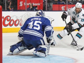 San Jose's Joe Thornton, right, gets a scoring attempt on Jonathan Bernier of the Toronto Maple Leafs Thursday in Toronto. (Photo by Claus Andersen/Getty Images)