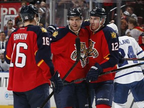 Belle River's Aaron Ekblad, centre, is congratulated by Jimmy Hayes, right, and Aleksander Barkov after scoring a second-period goal against the Toronto Maple Leafs Tuesday in Sunrise, Fla. (Photo by Joel Auerbach/Getty Images)