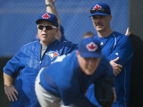 Toronto pitcher Aaron Sanchez, front, pitches in the bullpen as manager John Gibbons, left, and pitching coach Pete Walker watch during spring training in Dunedin, Fla. (THE CANADIAN PRESS/Nathan Denette)