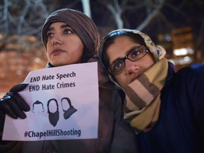 Women take part in a vigil for three young Muslims killed in Chapel Hill, North Carolina, at Dupont Circle on February 12, 2015 in Washington, DC. The three were killed by a neighbour in what police said was a dispute over parking and possibly a hate crime. AFP PHOTO/MANDEL NGANMANDEL NGAN/AFP/Getty Images