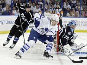 Toronto's James van Riemsdyk, centre, tires to score a goal on Ben Bishop, right, while being chased by Nikita Nesterov Thursday in Tampa, Fla. (AP Photo/Chris O'Meara)