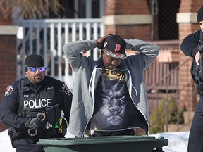 Heavily armed Windsor police officers arrest a man on Campbell Avenue in Windsor, Ont. on Monday, March 2, 2015. (DAN JANISSE/ The Windsor Star)