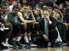Michigan State head coach Tom Izzo watches the final minutes of overtime in front of his bench against Wisconsin in the championship of the Big Ten Conference tournament in Chicago.  (AP Photo/Nam Y. Huh)
