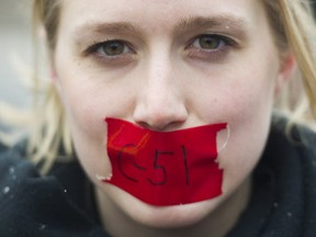 A woman protests on a national day of action against Bill C-51, the government's proposed anti-terrorism legislation, in Montreal, Saturday, March 14, 2015. THE CANADIAN PRESS/Graham Hughes