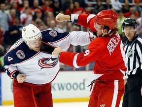 Columbus Blue Jackets defenseman Kevin Connauton (4) and Detroit Red Wings left wing Justin Abdelkader (8) fight in the second period of an NHL hockey game in Detroit Thursday, March 12, 2015. (AP Photo/Paul Sancya)