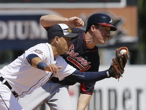Atlanta's Joe Benson, right, is caught stealing second by Detroit Tigers shortstop Jose Iglesias during the sixth inning of a spring training exhibition game Monday in Lakeland, Fla. (AP Photo/Carlos Osorio)