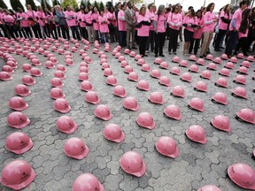 In this file photo, hundreds of New Yorkers wearing pink shirts wait to pick up pink hardhats that they will wear as they form a pink ribbon in honor of Breast Cancer Awareness Month, Tuesday, Oct. 7, 2014 in New York. The event, sponsored by Emcor Group, was held outside the Alexandria Center for Life Sciences. Breast Cancer Awareness Month is an annual campaign to increase awareness of the disease.(AP Photo/Mark Lennihan)